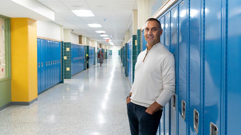 Image of John Liporace ’88 by his old locker at Hoosick Falls High School. 